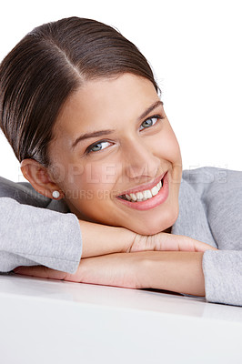 Buy stock photo Studio shot of a beautiful young woman resting on a table against a white background
