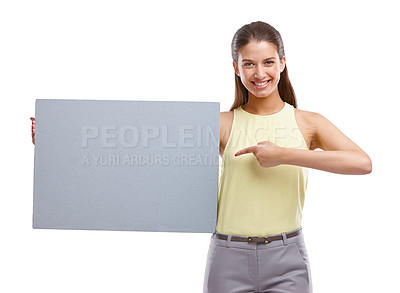 Buy stock photo Studio shot of a beautiful young woman holding a blank placard against a white background
