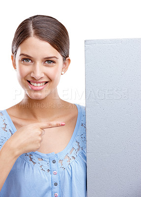 Buy stock photo Portrait, pointing and poster with a woman in studio isolated on a white background holding a blank sign for branding. Logo, marketing and brand with a female showing mockup space for advertising