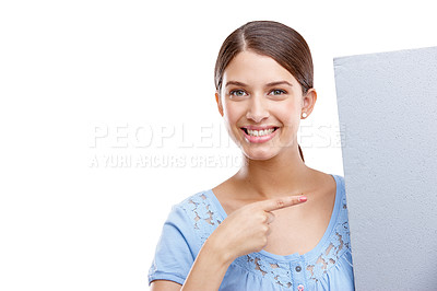 Buy stock photo Portrait, point and poster with a woman in studio isolated on a white background holding a blank sign for branding. Logo, marketing and brand with a female showing mockup space for advertising