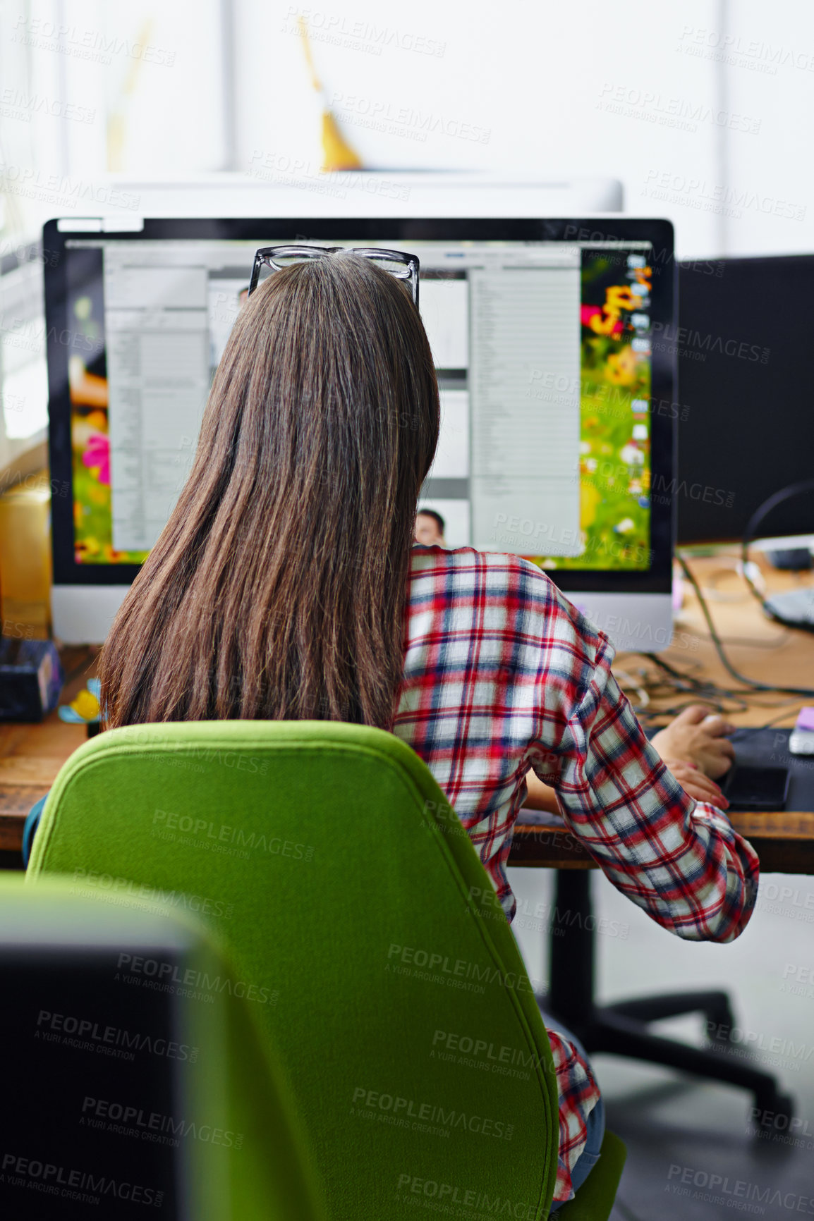 Buy stock photo Rearview shot of a female designer working on her computer