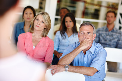 Buy stock photo Shot of coworkers watching a presentation in a casual office environment