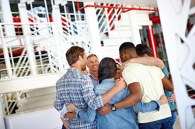Buy stock photo Shot of a group of coworkers huddled together at the office