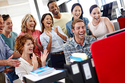 Buy stock photo Shot of a diverse group of coworkers excited about something they see on the computer