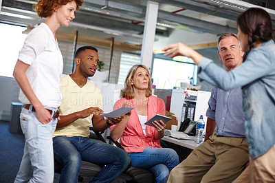 Buy stock photo Shot of a diverse group of coworkers discussing ideas in a casual work environment