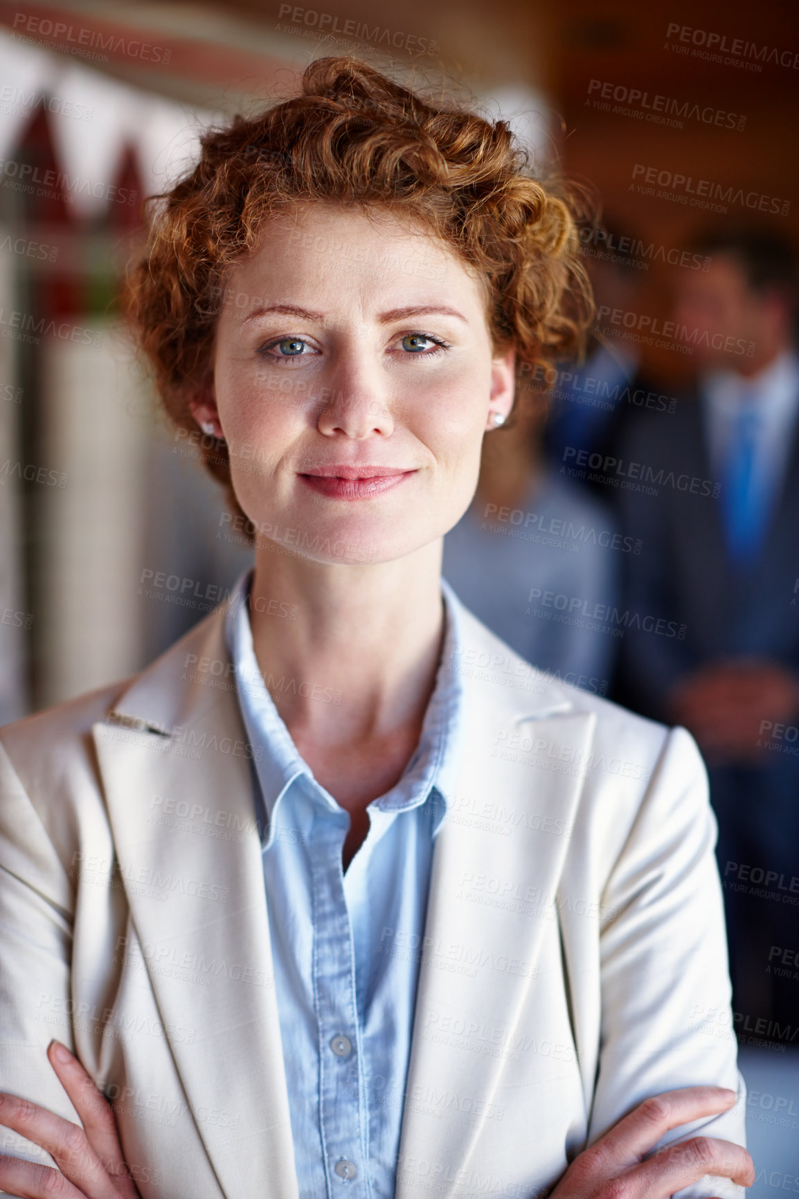 Buy stock photo Shot of a confident businesswoman standing in front of her team at the office