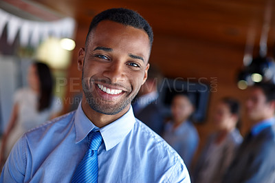 Buy stock photo Shot of a confident businessman standing in front of his team at the office
