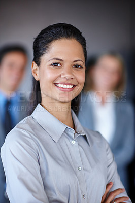 Buy stock photo Shot of a confident businesswoman standing in front of her team at the office