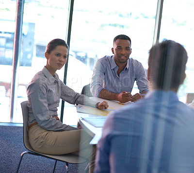 Buy stock photo Shot of group of colleagues having a meeting in the boardroom at the office