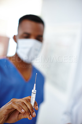 Buy stock photo Closeup shot of a surgeon holding a syringe in his hand