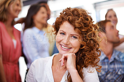 Buy stock photo Portrait of an attractive businesswoman with her colleagues in the background
