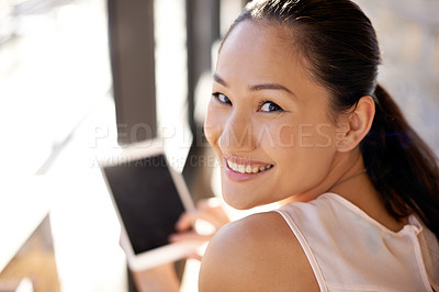 Buy stock photo Portrait of a beautiful woman sitting with her digital tablet indoors