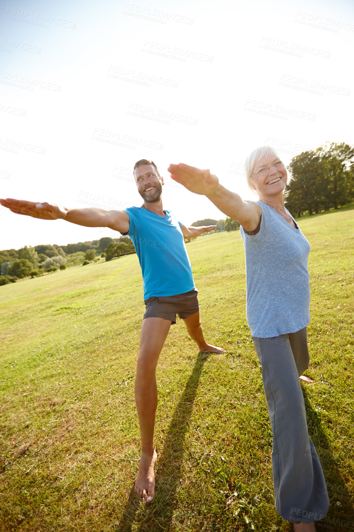 Buy stock photo Couple, stretching and happy with yoga in park for exercise, balance and mobility in nature. Smile, mature people and warrior pose on grass for arm workout, holistic wellness and mockup with pilates