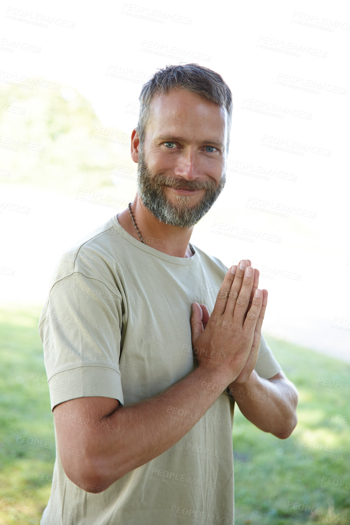 Buy stock photo Portrait, yoga and man with routine, meditation and smile with wellness, nature and lotus. Face, person and guy with exercise, outdoor or joy with break, zen and chakra with fitness or hands together