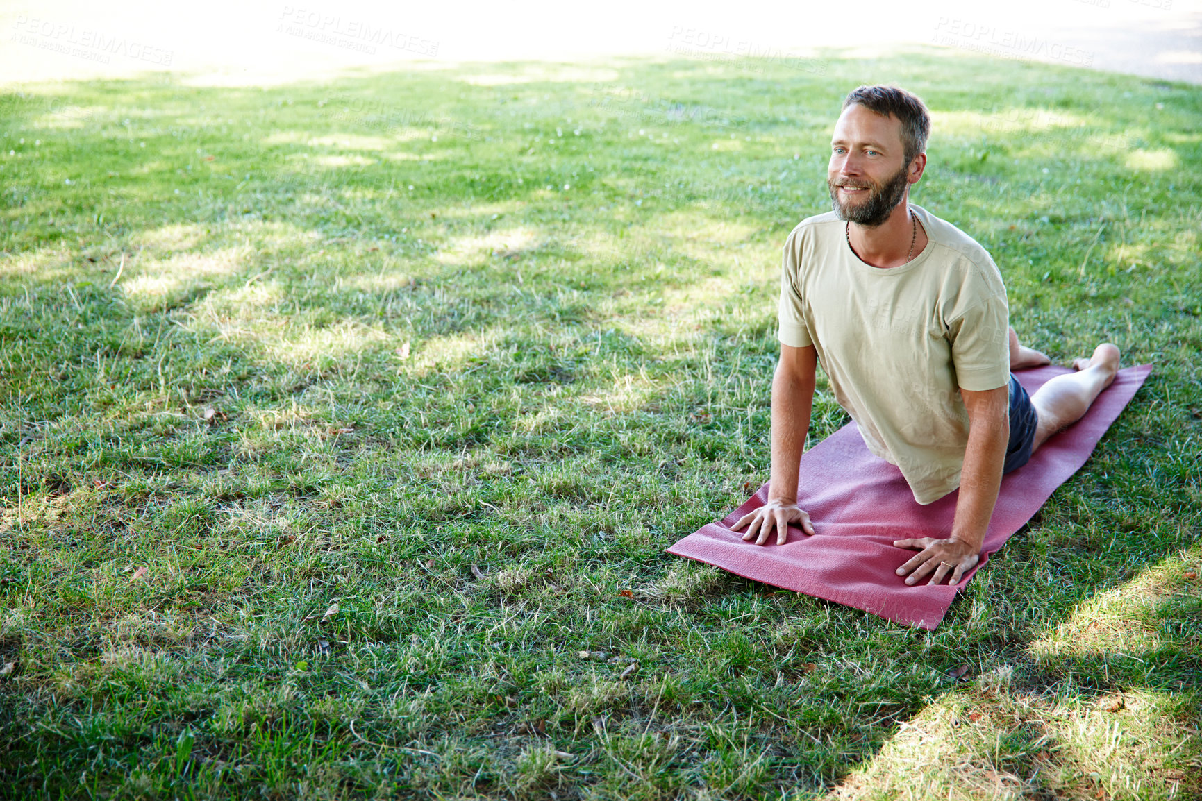 Buy stock photo Park, man and smile on yoga mat with stretching for fitness, exercise and workout in Germany. Male person, outdoor and happy or satisfied on grass for self care, health and wellness as routine