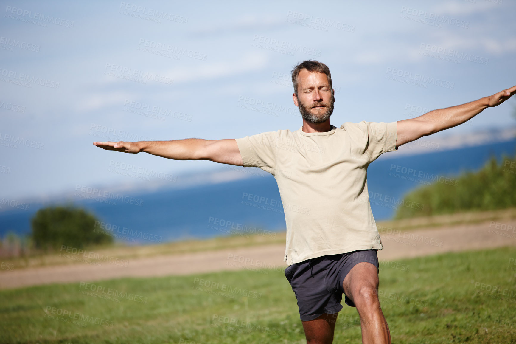 Buy stock photo Park, man and stretching in nature with yoga for exercise, balance and mobility on grass. Pilates, mature yogi and warrior pose on lawn for workout, holistic wellness and posture with fitness outdoor