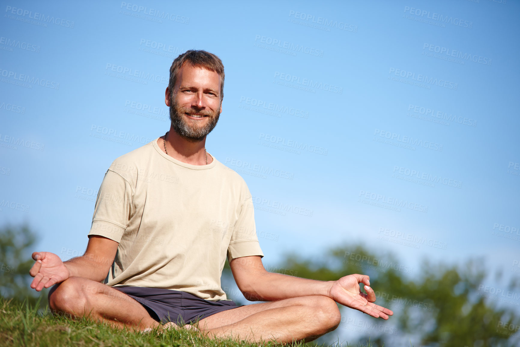 Buy stock photo Yoga, portrait and happy man with lotus on grass outdoor for exercise, meditation or chakra for holistic fitness. Mature, yogi and pose for healthy mind, body wellness and relax with space in Sweden