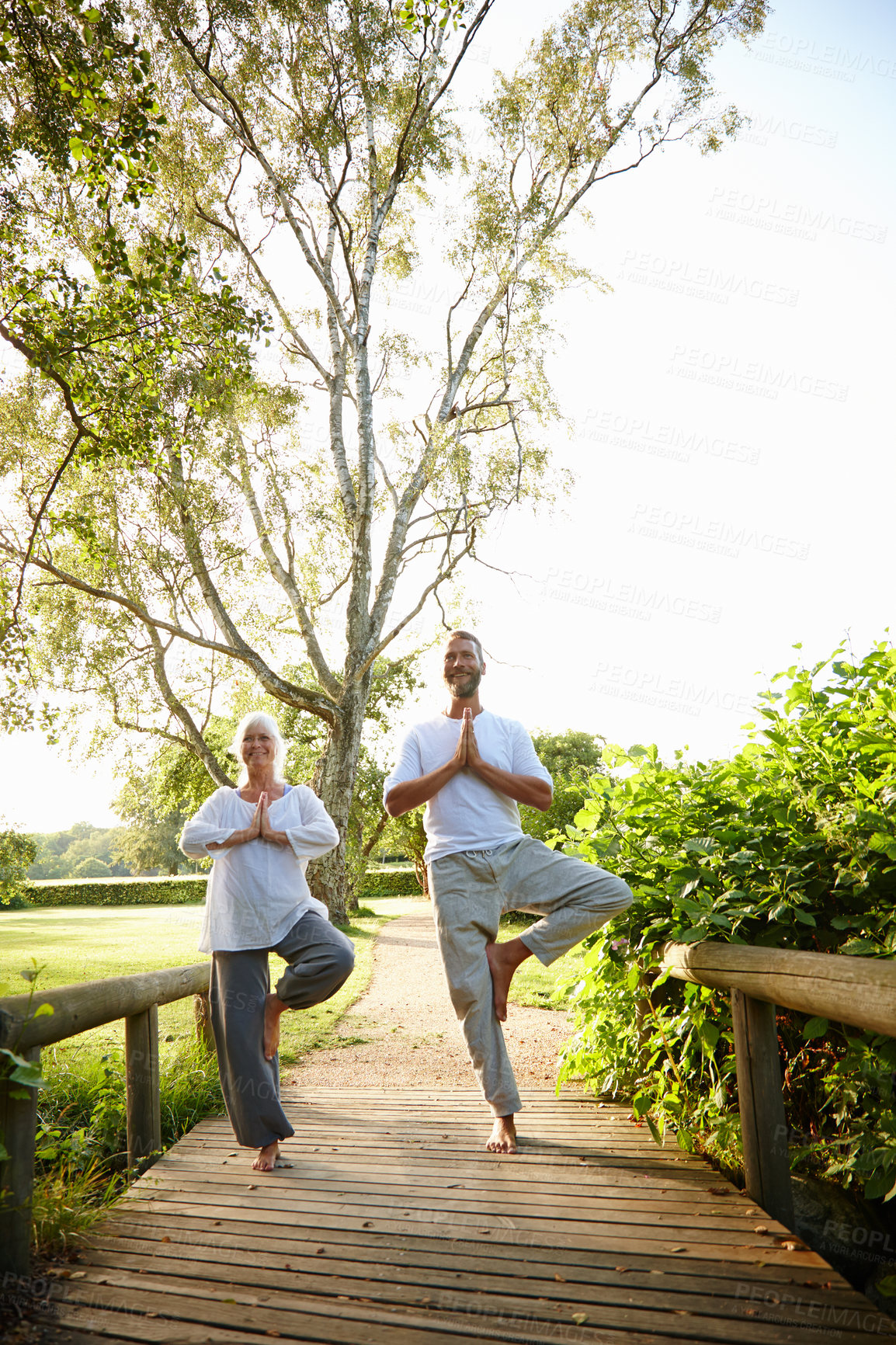 Buy stock photo Namaste, yoga and meditation for people, outdoor and fitness in nature, balance and mindfulness of aura. Chakra, lens flare and faith in park, wellness and spiritual for peace, soul and together