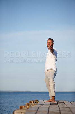 Buy stock photo Man, portrait and yoga at ocean with space, smile and peace for spiritual healing. Mature fitness person, warrior pose and pilates on sea dock for wellness, exercise and healthy posture in nature