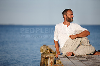 Buy stock photo Ocean, man and yoga for stretching on boardwalk for fitness and exercise in German. Mature person, outdoor and smile or satisfied on break with self care, wellness and mental health at seaside