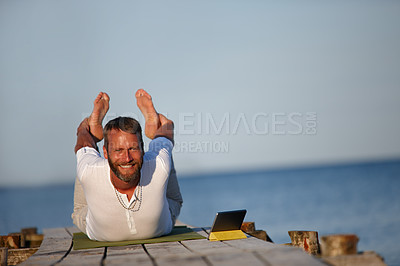 Buy stock photo Smile, man and stretching for yoga by ocean with flexible body, spiritual wellness and balance performance. Happy, mature person and warm up for chakra peace, mindfulness healing and fitness outdoor
