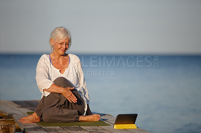 Buy stock photo Mature woman, yoga and lake with tablet for online tutorial, lesson or virtual class in nature. Senior, female person or yogi with smile for holistic training, workout or exercise by beach or ocean