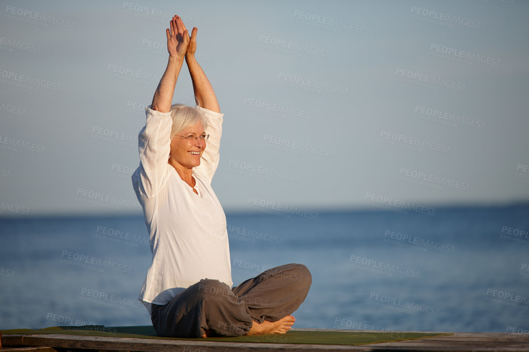 Buy stock photo Mature, happy woman and yoga with meditation by lake for exercise, workout or holistic balance in nature. Senior, female person or yogi with smile for training, health or wellness by beach or ocean