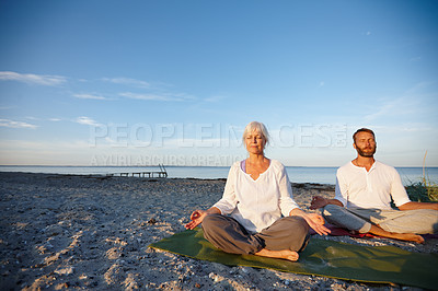 Buy stock photo Lotus, couple and meditation for yoga by ocean with holistic care, spiritual wellness and mindfulness zen. Mature people, chakra and pilates peace, mindset healing and performance for fitness outdoor