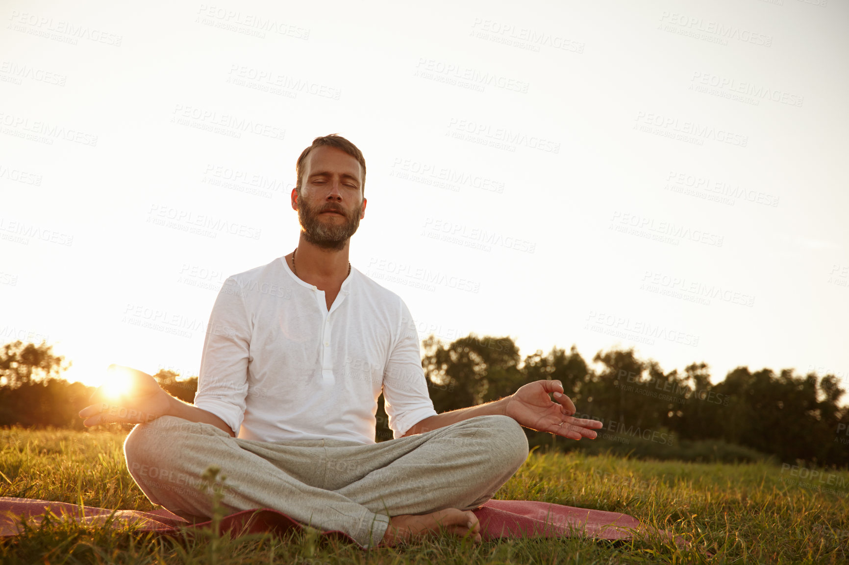 Buy stock photo Man, outdoor and sunset for lotus yoga position, meditation and mindfulness for healing chakra. Male person, sun flare and holistic pose for spiritual awareness, morning fitness and peace in exercise