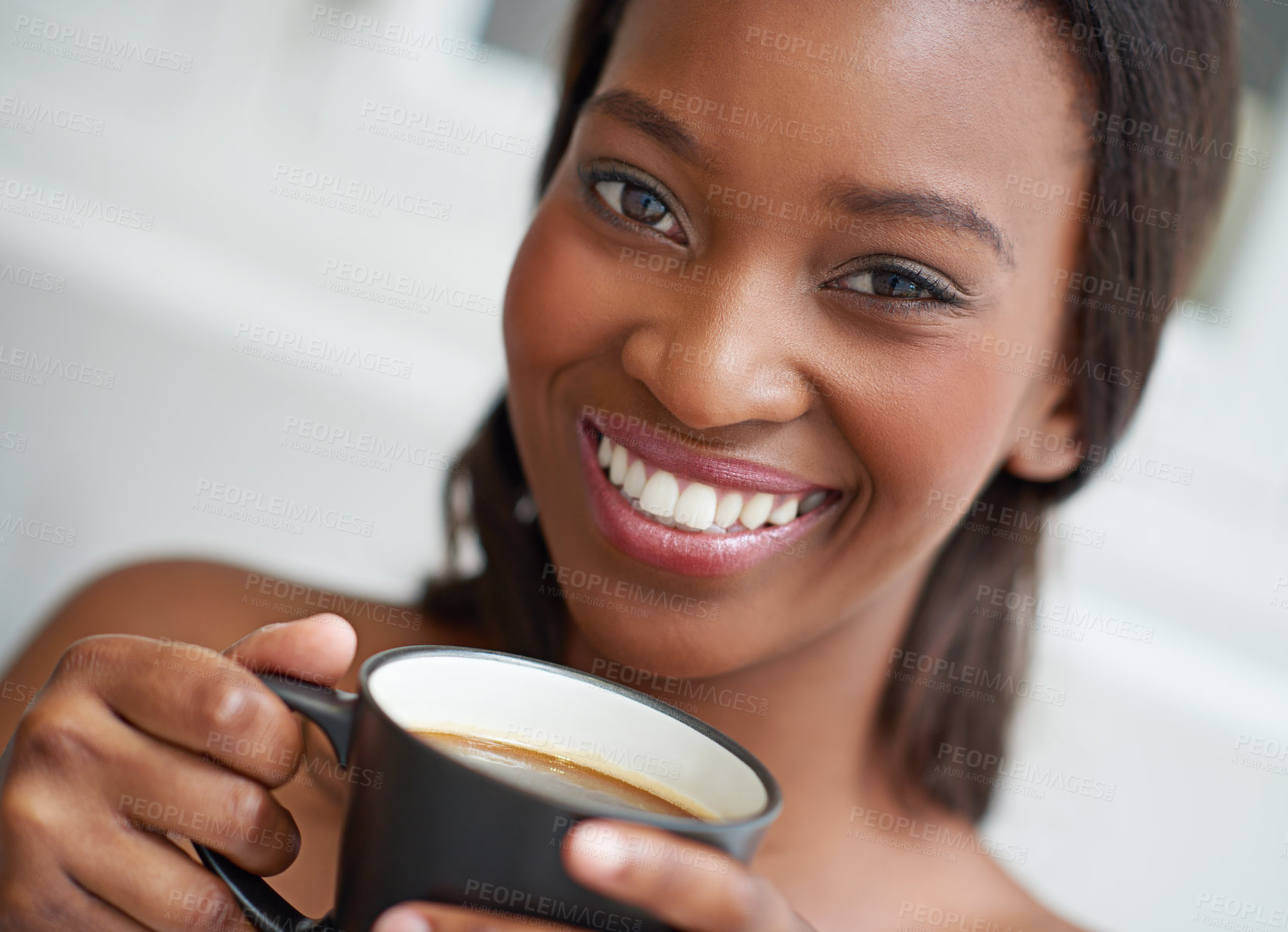 Buy stock photo A young ethnic woman enjoying a cup of coffee