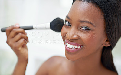 Buy stock photo Shot of a beautiful young woman applying blush with a makeup brush