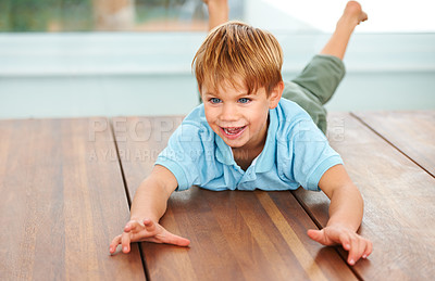 Buy stock photo Child, excited and fantasy game on floor in family home, security and looking at object, energy and action with smile. Boy, happiness and fun in living room for love, care and play in kindergarten