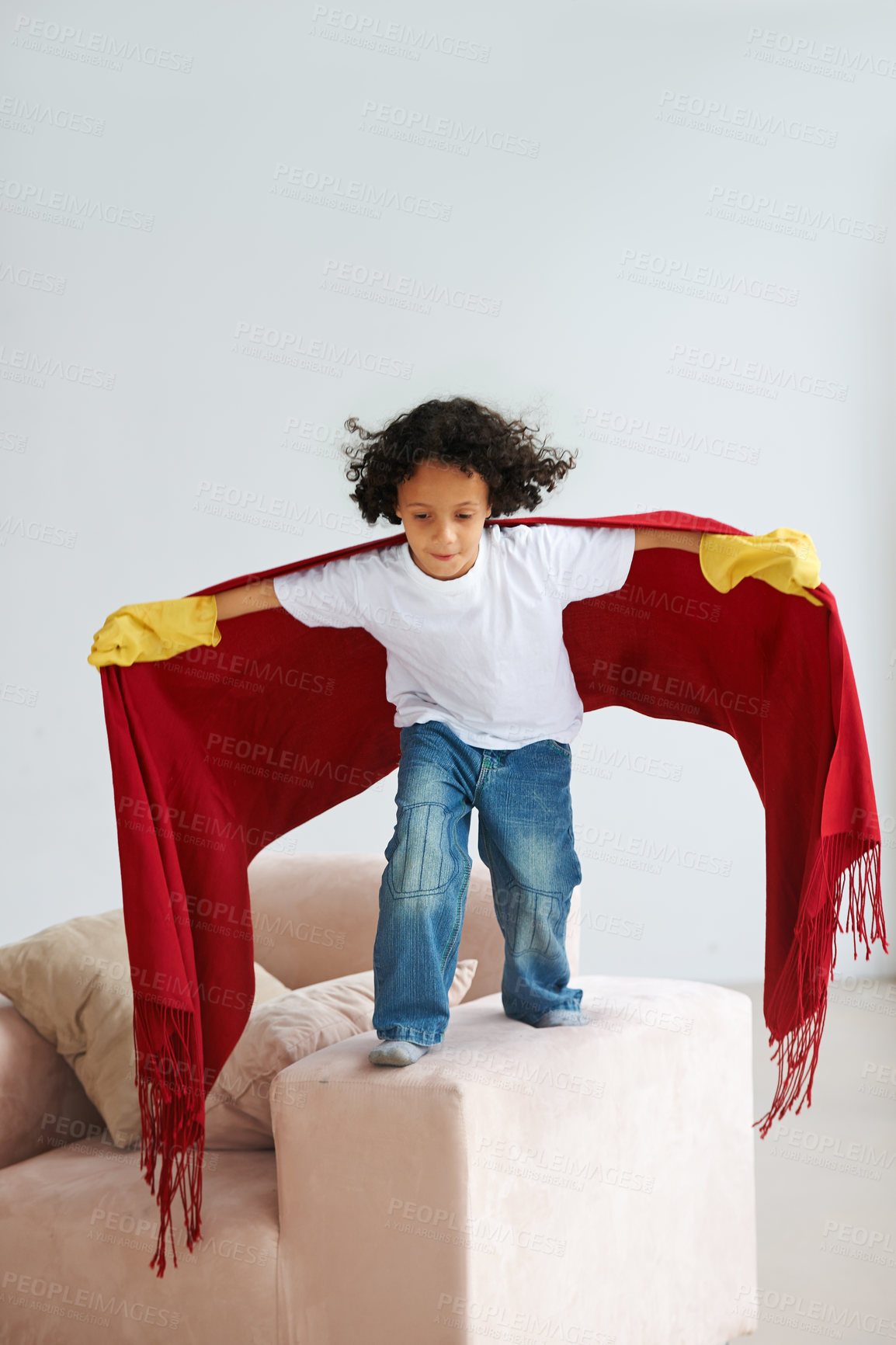 Buy stock photo Jump, children and a boy superhero in a costume on a sofa in the living room of his home for playing a game. Flying, growth and fantasy with a young kid in a cape for justice or safety cosplay