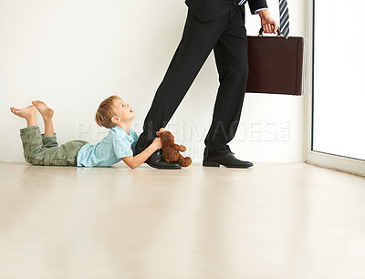 Buy stock photo Work, home and child sad by father, pull leg and fear with anxiety, stress and mental health. Businessman, kid and tantrum on floor with dad late, professional career and accountant in family house
