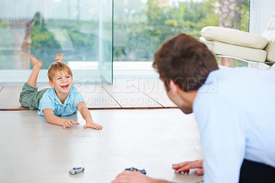 Buy stock photo Father, child and playing on floor with toys, family home and happy with support of businessman. Man, boy or together to relax with smile, fantasy game and learning  trust papa for love of cars


