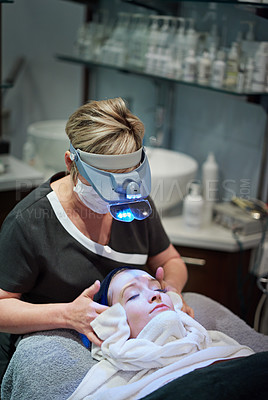 Buy stock photo Shot of a woman getting a facial treatment at a clinic