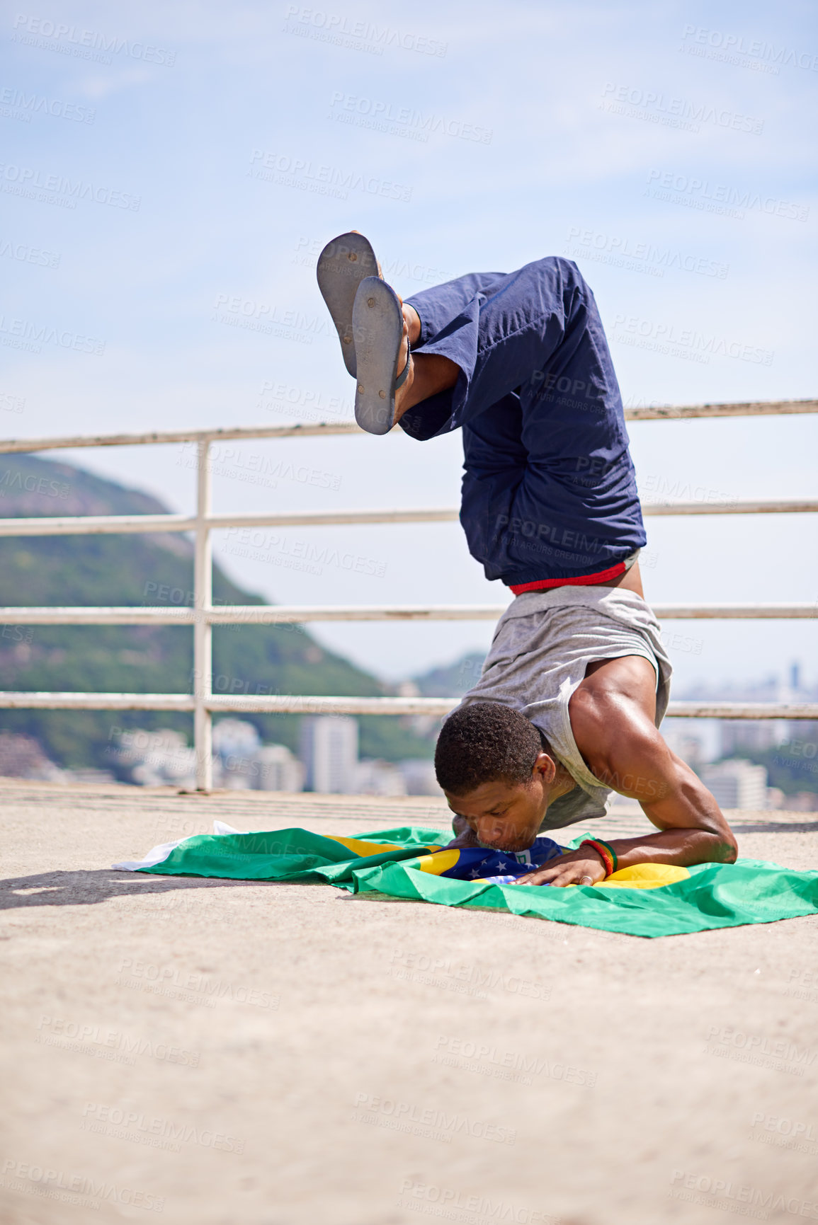 Buy stock photo Low angle shot of a young male breakdancer in an urban setting
