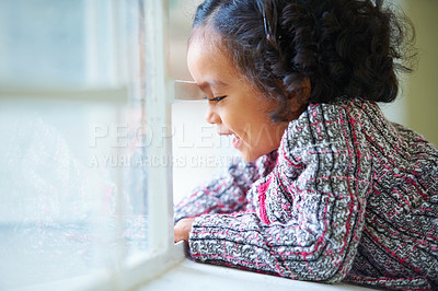 Buy stock photo Happy, morning and a child looking from a window in a house for the view with a smile. Cute, youth and a girl kid in a home for playing, childhood or relax while laughing or thinking in a room