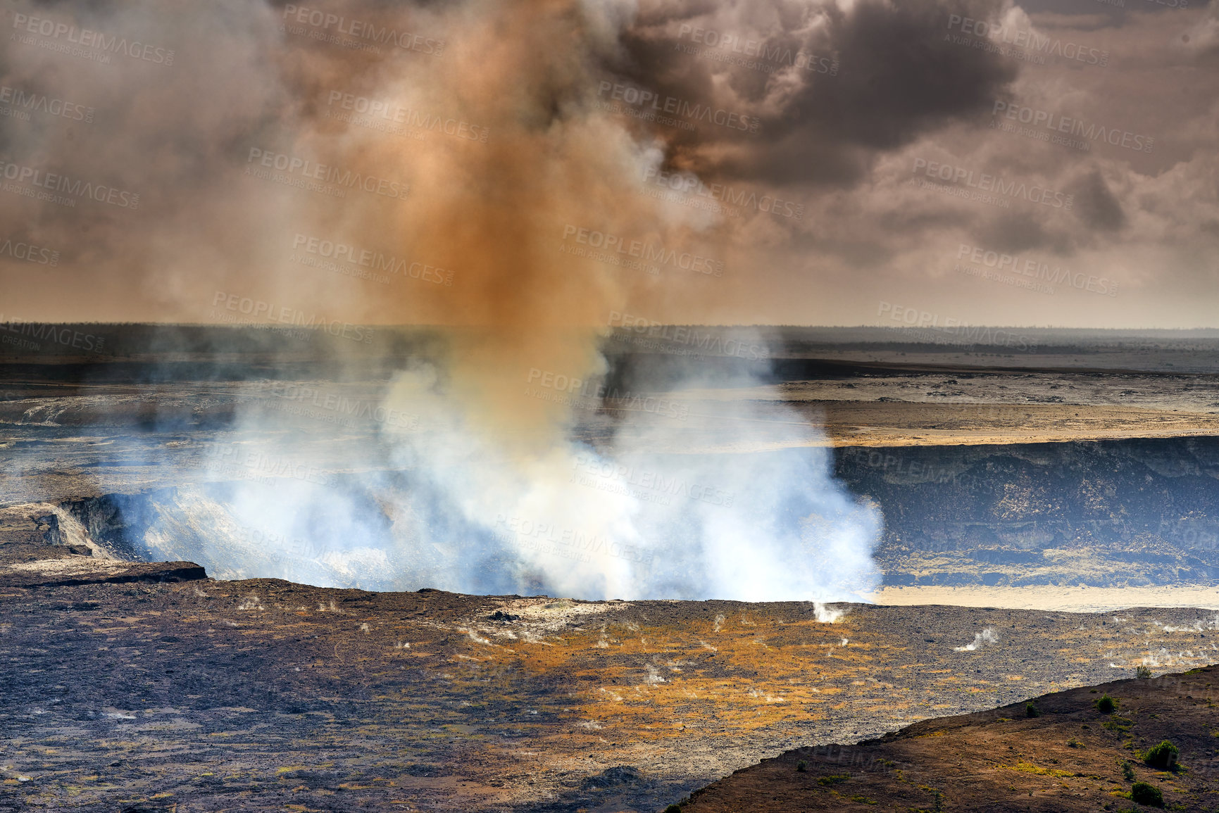 Buy stock photo Mouna Kea most active volcano on a cloudy day. Extreme panoramic landscape of Hawaiian mountains and rocky surface. Overcast skies with a steaming volcanic area. Smoke coming out of crater