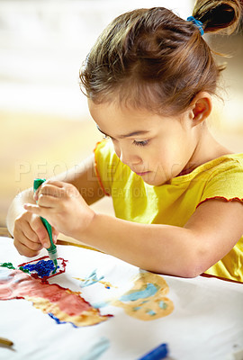 Buy stock photo Shot of an adorable little girl making a mess while painting