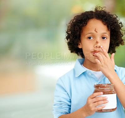 Buy stock photo Cute, portrait and kid with chocolate spread at a home with delicious, sweet snack or treat. Smile, happy and face of young boy child from Mexico eating nutella jar licking lips at modern house.