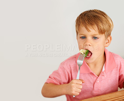 Buy stock photo Child, broccoli or vegetables fork eat for healthy nutrition meal, dinner hunger at kitchen table. Male person, kid and hand wall background or fibre lunch for development, youth or organic taste