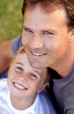 Buy stock photo Portrait, happy man and son sitting on grass, cute bonding together with care and love from above. Fun, father and child on ground in backyard of home with smile, trust and support with dad and boy.