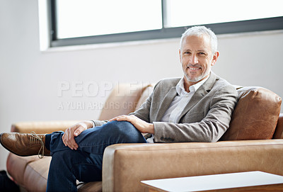 Buy stock photo Portrait of a handsome mature man relaxing on the sofa at home