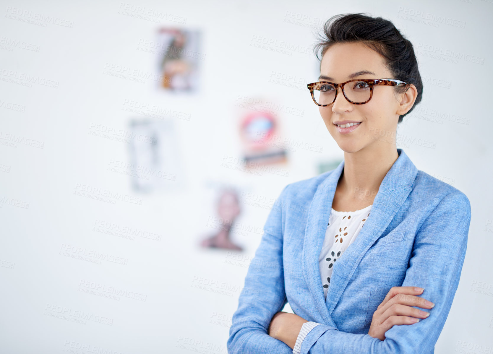 Buy stock photo Shot of a beautiful young woman working in a modern office. The commercial designs displayed represent a simulation of a real product and have been changed or altered enough by our team of retouching and design specialists so that they don't have copyright infringements