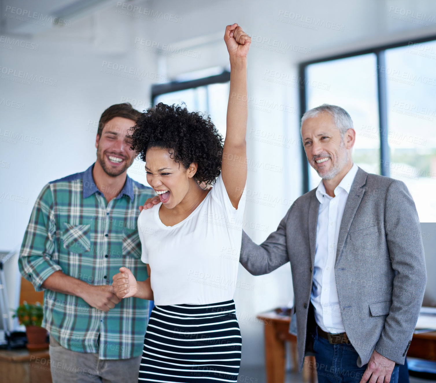 Buy stock photo Shot of a excited coworkers cheering in an office
