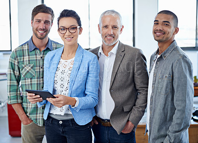 Buy stock photo Portrait of a group of colleagues using a digital tablet while standing in an office