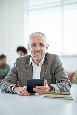 Buy stock photo Portrait of a mature businessman sitting at a table in an office
