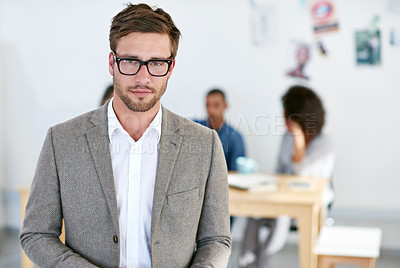 Buy stock photo Portrait of a young man standing in an office. The commercial designs displayed represent a simulation of a real product and have been changed or altered enough by our team of retouching and design specialists so that they don't have copyright infringements