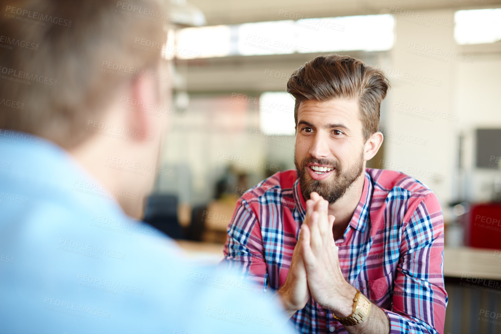 Buy stock photo Shot of a young male designer having a conversation with a colleague